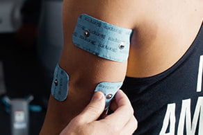 Compex electrodes on a person's elbow